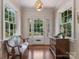 Bright foyer with hardwood floors, decorative lighting, a bench, and a view through the glass front door to the outside at 2410 Vernon Dr, Charlotte, NC 28211