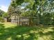 Greenhouse in a backyard with glass panels, providing a nurturing environment for plants at 2410 Vernon Dr, Charlotte, NC 28211