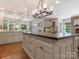 An expansive kitchen island features seating and custom cabinets for storage at 2410 Vernon Dr, Charlotte, NC 28211