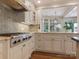 Gourmet kitchen features stainless range, tile backsplash, and custom cabinets at 2410 Vernon Dr, Charlotte, NC 28211