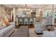 Open floor plan showcases the kitchen island with seating, hardwood floors, and elegant furniture at 2410 Vernon Dr, Charlotte, NC 28211