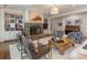 Cozy living room with a stone fireplace, hardwood floors, built-in bookshelves, and stylish furnishings at 2410 Vernon Dr, Charlotte, NC 28211