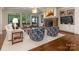 Spacious living room with a stone fireplace, hardwood floors, large windows, and built-in bookshelves at 2410 Vernon Dr, Charlotte, NC 28211