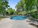 Backyard pool with lounge chairs surrounded by mature trees and greenery at 2410 Vernon Dr, Charlotte, NC 28211