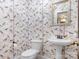 Charming powder room features unique wallpaper, pedestal sink, and updated fixtures at 2410 Vernon Dr, Charlotte, NC 28211