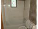 Bathroom with tiled tub and shower combination and a decorative stained glass window at 2583 Robinson Rd, Newton, NC 28658