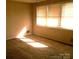 Bright and sunny bedroom featuring neutral carpet and large window with blinds at 2583 Robinson Rd, Newton, NC 28658