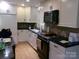 Well-lit kitchen featuring modern appliances, white cabinetry, and tile backsplash at 2583 Robinson Rd, Newton, NC 28658