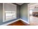 A grey bedroom with hardwood floors, a window, and a doorway to another room at 2645 Kool Park Ne Rd, Hickory, NC 28601