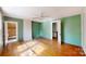 A green-painted room with hardwood floors, white ceiling, and a ceiling fan at 2645 Kool Park Ne Rd, Hickory, NC 28601