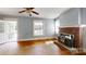 Bright living room with wood floors, a brick fireplace, and lots of natural light at 2645 Kool Park Ne Rd, Hickory, NC 28601