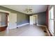 A room with grey and red walls, hardwood floors, a ceiling fan, and doors to other rooms at 2645 Kool Park Ne Rd, Hickory, NC 28601