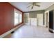 A room with red and grey walls, wood floors, a window, and a decorative fireplace at 2645 Kool Park Ne Rd, Hickory, NC 28601