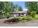 Beautiful exterior view with manicured front yard, brick accents, two-car garage, and a side deck at 2750 Victory Ct, Fort Mill, SC 29715