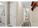 Hallway with hardwood floors and entryways leading to the laundry room and a bedroom at 2750 Victory Ct, Fort Mill, SC 29715