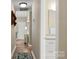 Hallway view featuring wood floors, a decorative table, and a glimpse into the bathroom at 2750 Victory Ct, Fort Mill, SC 29715