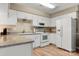 Well-lit kitchen featuring white cabinets, stainless steel appliances, and granite countertops at 2750 Victory Ct, Fort Mill, SC 29715