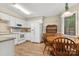 Bright kitchen with white appliances, wood cabinets, and adjacent dining area, perfect for Gathering meals at 2750 Victory Ct, Fort Mill, SC 29715