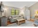 Cozy living room featuring a comfortable sofa, wooden floors, and a bright window with a view at 2750 Victory Ct, Fort Mill, SC 29715
