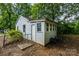 A backyard showing the exterior of a building with a gray door at 2905 Grimes St, Charlotte, NC 28206