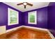 This bedroom has vibrant walls, hardwood floors, and a ceiling fan at 2905 Grimes St, Charlotte, NC 28206