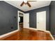 Bedroom showcasing hardwood floors, ceiling fan, and door to additional space at 2905 Grimes St, Charlotte, NC 28206