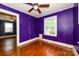 Bedroom features hardwood floors, ceiling fan, and a window with backyard view at 2905 Grimes St, Charlotte, NC 28206