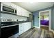 Updated kitchen with white cabinets, stainless steel appliances, and modern countertops at 2905 Grimes St, Charlotte, NC 28206