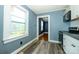 Cozy kitchen showcasing a window, white cabinets, and wood-look flooring at 2905 Grimes St, Charlotte, NC 28206