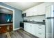 Well-lit kitchen featuring white cabinets, stainless steel appliances, and wood-look flooring at 2905 Grimes St, Charlotte, NC 28206