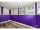 This room has purple walls, wood-look flooring, and natural lighting at 2905 Grimes St, Charlotte, NC 28206