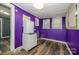 This room has purple walls, wood-look flooring, and a window at 2905 Grimes St, Charlotte, NC 28206