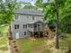 Spacious backyard featuring a screened porch, wooden deck, mature trees, and a cozy fire pit area for outdoor enjoyment at 2907 Notchview Ct, Charlotte, NC 28210