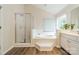 Bathroom featuring a tub, shower, and large window for natural light at 2907 Notchview Ct, Charlotte, NC 28210