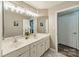 Bathroom featuring a double sink vanity with white cabinets and unique patterned tile flooring at 2907 Notchview Ct, Charlotte, NC 28210