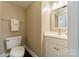 Neutral-toned powder room features a vanity and wood-look flooring at 2907 Notchview Ct, Charlotte, NC 28210