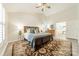 Bedroom showcasing a stylish bed, shuttered windows, and wood-look floors at 2907 Notchview Ct, Charlotte, NC 28210