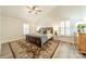 A cozy bedroom with a vaulted ceiling, shuttered windows, and wood-look flooring at 2907 Notchview Ct, Charlotte, NC 28210