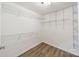 Walk-in closet with wood-look floors and multiple shelves at 2907 Notchview Ct, Charlotte, NC 28210