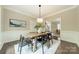 Open dining room featuring a modern light fixture and an elegant table set at 2907 Notchview Ct, Charlotte, NC 28210
