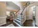 Welcoming foyer featuring hardwood floors and a staircase with a white railing at 2907 Notchview Ct, Charlotte, NC 28210