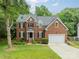 Charming brick home with a well-manicured lawn and two-car garage at 2907 Notchview Ct, Charlotte, NC 28210