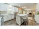 Open kitchen with an island, stainless steel appliances, and view to living room at 2907 Notchview Ct, Charlotte, NC 28210