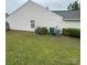 The side yard has green grass and trash cans at 3012 Longspur Dr, Matthews, NC 28105