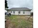 View of the backyard and back exterior of the home at 3012 Longspur Dr, Matthews, NC 28105