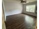 Bright bedroom with dark wood floors and a large window for ample natural light at 3012 Longspur Dr, Matthews, NC 28105