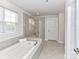 Luxurious bathroom with soaking tub, glass-enclosed shower and tiled walls provide a spa-like experience at 3023 Ballester Rd, Fort Mill, SC 29707