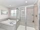 Bathroom featuring a large tub and a separate glass shower enclosure, providing a luxurious bathing experience at 3023 Ballester Rd, Fort Mill, SC 29707