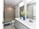 Bright bathroom with a double sink vanity, framed mirrors, and shower with patterned curtain at 3023 Ballester Rd, Fort Mill, SC 29707