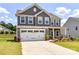 Two-story home showcasing a two car garage, manicured lawn, and professional landscaping at 3023 Ballester Rd, Fort Mill, SC 29707